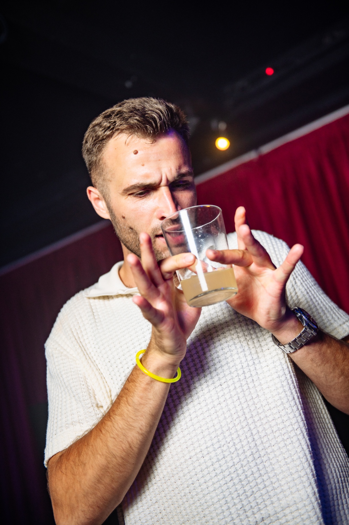 Guest with a drink under warm stage light