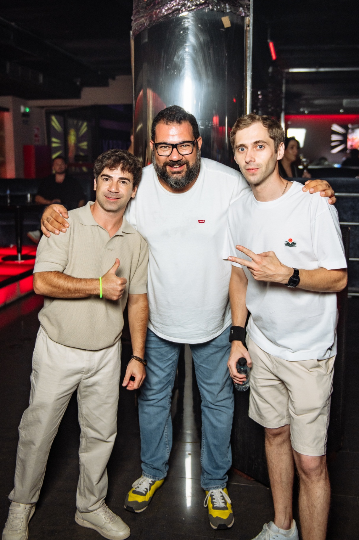 Three friends posing together on the dance floor