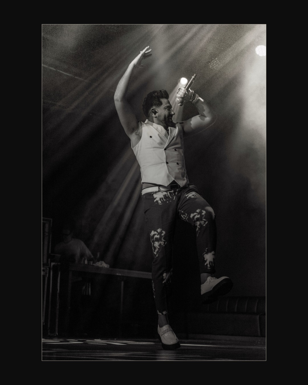 Performer on stage under harsh light during a NEBO night
